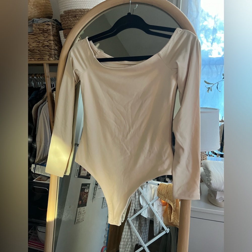 Nuuds off the shoulder bodysuit in the color bone.